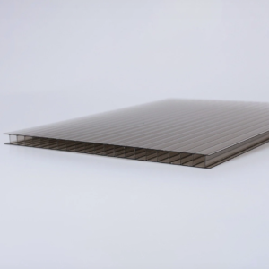 Close-up of a ribbed, translucent corrugated panel (likely polycarbonate) lying on a white surface.