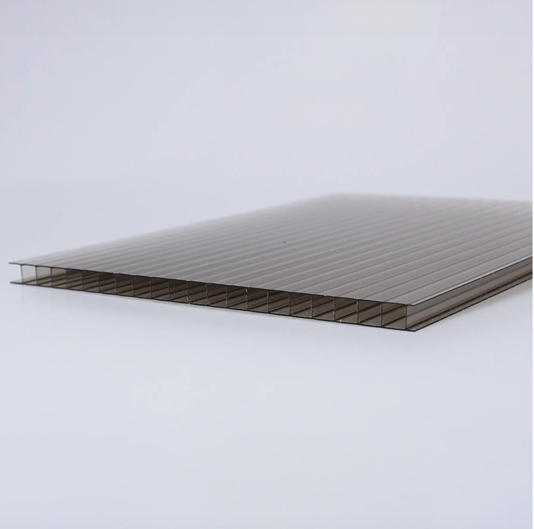 Close-up of a ribbed, translucent corrugated panel (likely polycarbonate) lying on a white surface.