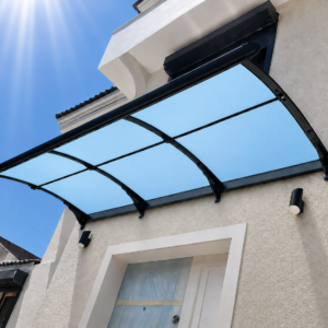 Glass blue-tinted canopy over a doorway on a stucco wall, sunny sky in the background